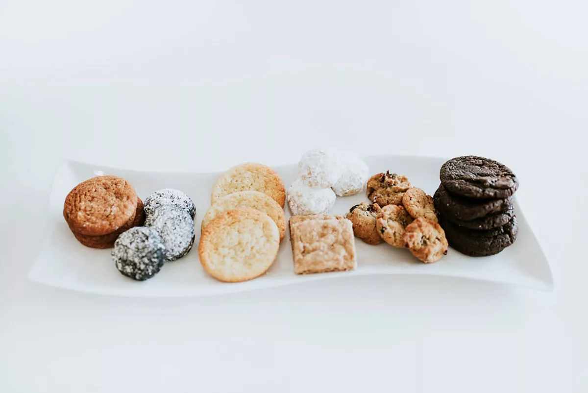 A tray of locally made cookies against a white background as catering for a local event.