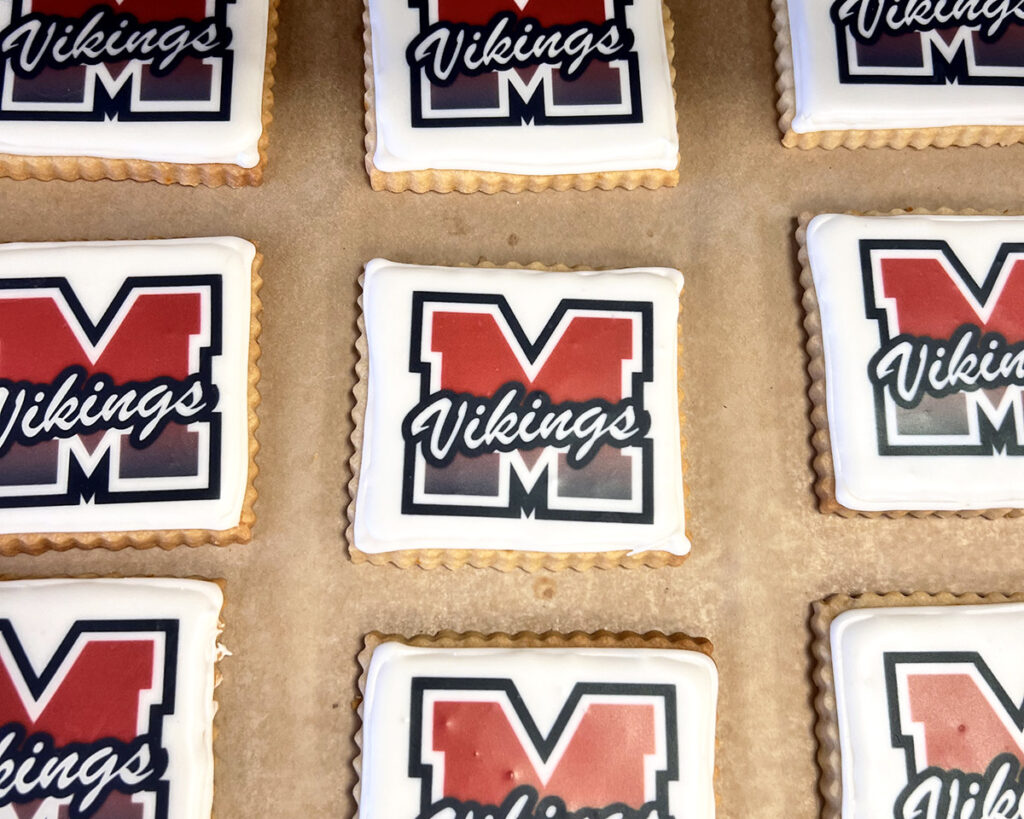 A tray of custom square-shaped sugar cookies for a graduation celebration.