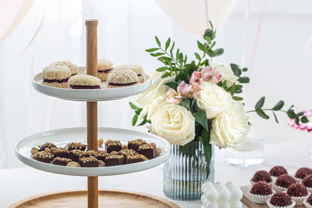 Wedding cookie table display with floral arrangement decorations