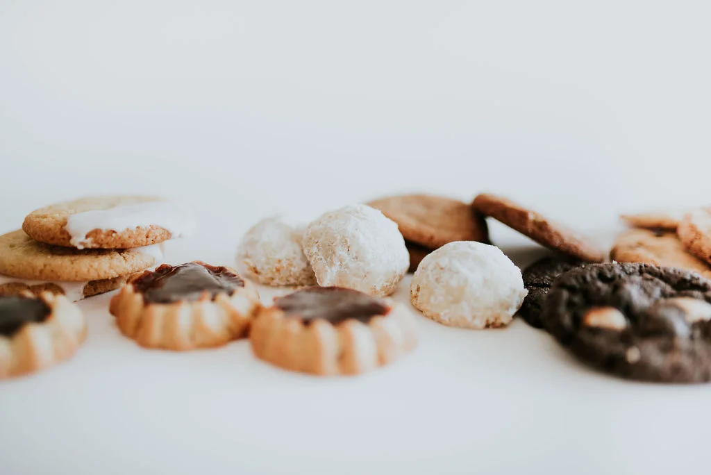 A selection of different gluten-free cookies on a white table